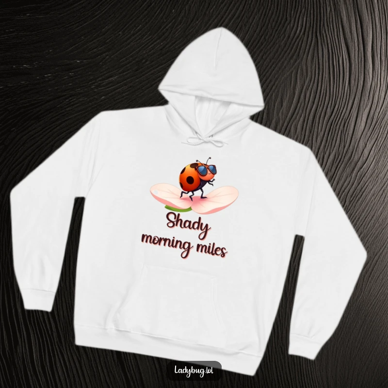 Funny ladybug hoodie with a ladybug wearing tiny sunglasses, cheerfully jogging across a petal, a humorous and cozy statement.