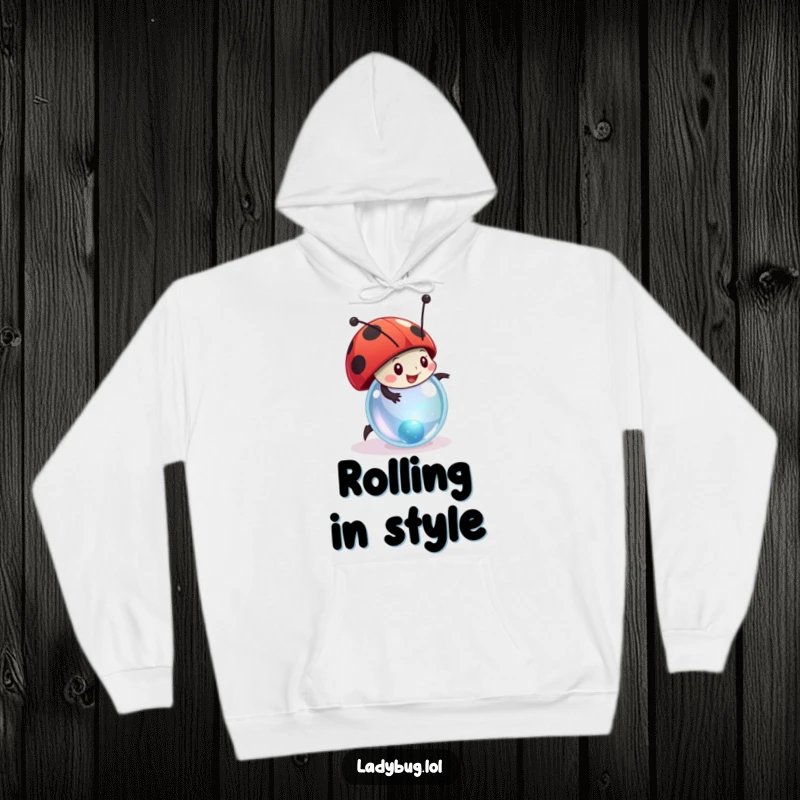Funny ladybug hoodie featuring a happy character joyfully rolling a tiny, sparkling marble, perfect for cozy fun.