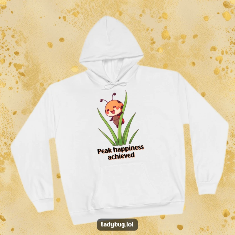 Funny hoodie featuring a joyful ladybug character happily climbing a tall blade of grass, symbolizing ambition and joy.