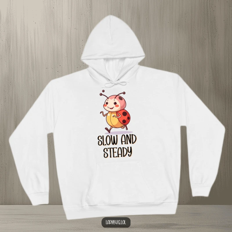 Funny hoodie showcasing a cheerful ladybug character with determined antennae, captured mid-jog, embodying motivation and happiness.