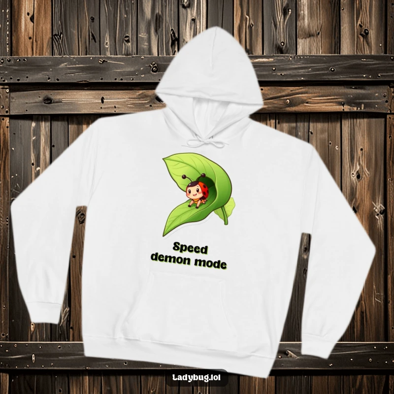 Funny ladybug hoodie depicting a cheerful insect character zooming down a leaf like a slide, embracing the thrill.