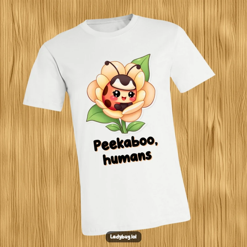 Funny t-shirt featuring a giggling ladybug hidden within a flower, capturing a moment of playful secrecy.